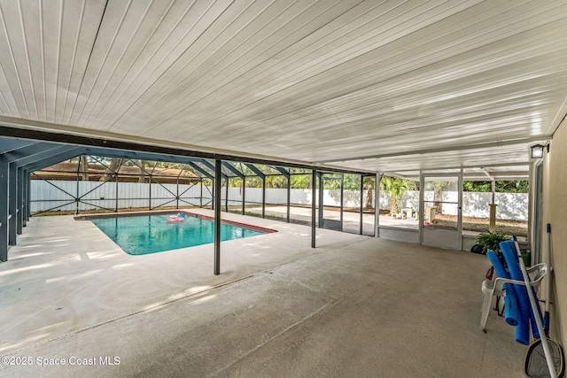 view of pool featuring a fenced in pool, a fenced backyard, glass enclosure, and a patio area