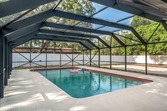 view of swimming pool with a fenced in pool, a lanai, a fenced backyard, and a patio area