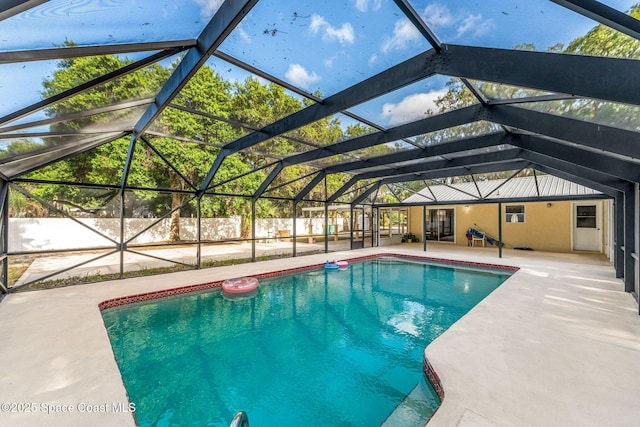 view of swimming pool featuring a fenced in pool, fence, a patio, and glass enclosure