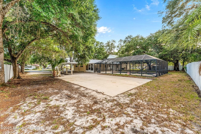 exterior space featuring fence, a lanai, and a carport