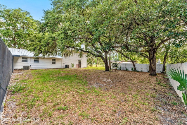 view of yard featuring central AC unit and a fenced backyard