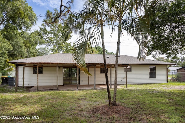 back of house featuring a lawn, cooling unit, and a patio area