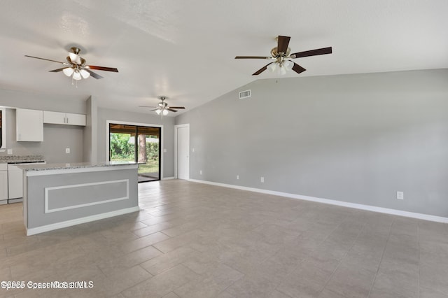 unfurnished living room featuring baseboards, ceiling fan, vaulted ceiling, and visible vents