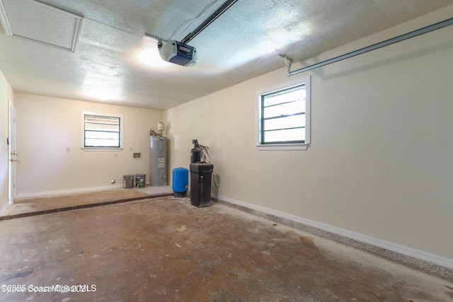 garage featuring water heater, baseboards, and a garage door opener
