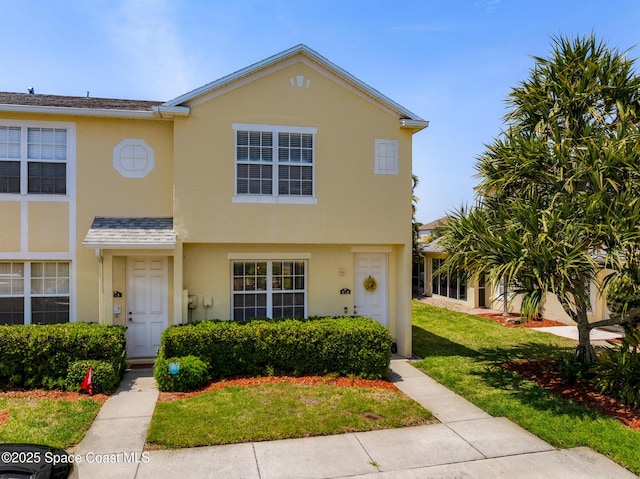 2990 S Fiske Blvd Unit C4, Rockledge, FL 32955 - townhome / multi-family property with stucco siding and a front lawn