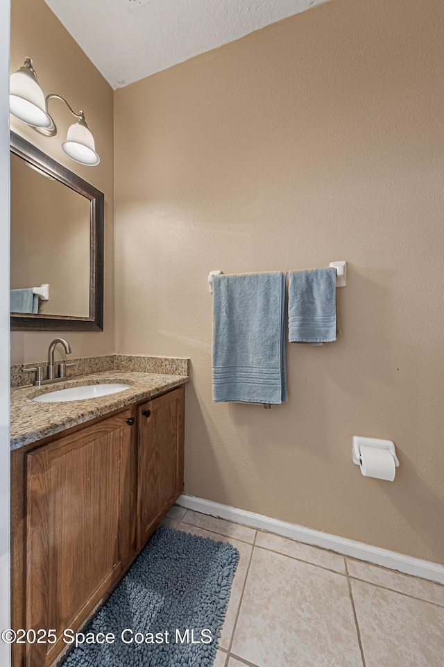 2990 S Fiske Blvd Unit C4, Rockledge, FL 32955 - bathroom with tile patterned floors, baseboards, and vanity
