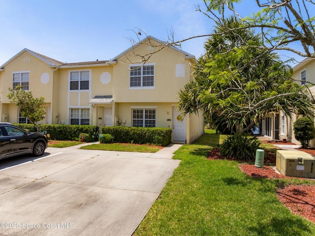 2990 S Fiske Blvd Unit C4, Rockledge, FL 32955 - view of front of property with a front lawn, stucco siding, and uncovered parking