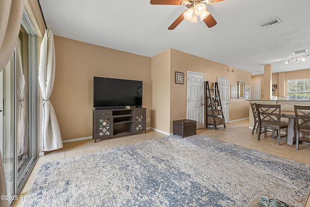 2990 S Fiske Blvd Unit C4, Rockledge, FL 32955 - tiled living area featuring ceiling fan, baseboards, and rail lighting