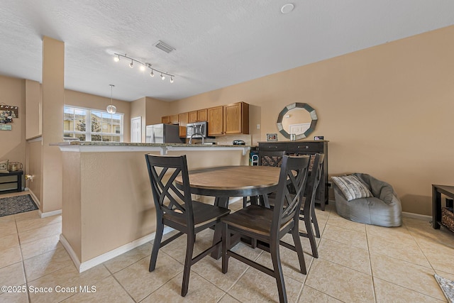 2990 S Fiske Blvd Unit C4, Rockledge, FL 32955 - dining space featuring light tile patterned floors, baseboards, and a textured ceiling