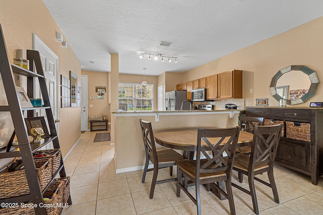 2990 S Fiske Blvd Unit C4, Rockledge, FL 32955 - dining room with light tile patterned floors, a textured ceiling, and baseboards