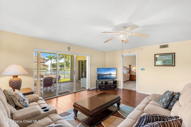 602 Shorewood Dr Unit A201, Cape Canaveral, FL 32920 - living area featuring wood finished floors, a ceiling fan, a textured ceiling, and baseboards