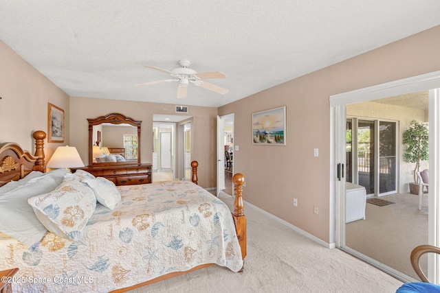 602 Shorewood Dr Unit A201, Cape Canaveral, FL 32920 - bedroom with access to exterior, light carpet, baseboards, a ceiling fan, and a textured ceiling