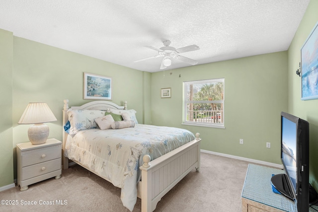 602 Shorewood Dr Unit A201, Cape Canaveral, FL 32920 - bedroom with light colored carpet, baseboards, a textured ceiling, and ceiling fan