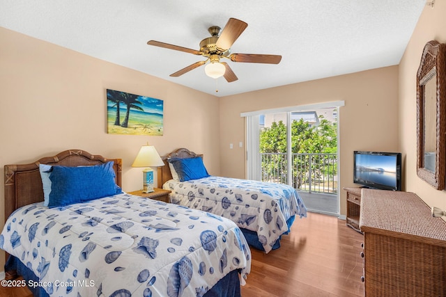602 Shorewood Dr Unit A201, Cape Canaveral, FL 32920 - bedroom featuring access to outside, wood finished floors, and a ceiling fan