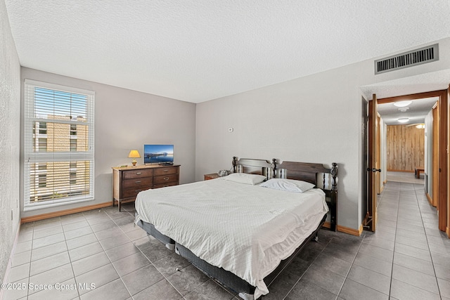 tiled bedroom with a textured ceiling