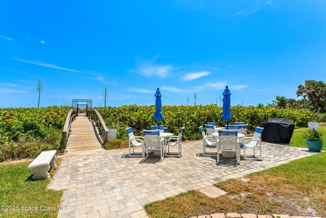 view of patio with area for grilling and outdoor dining area