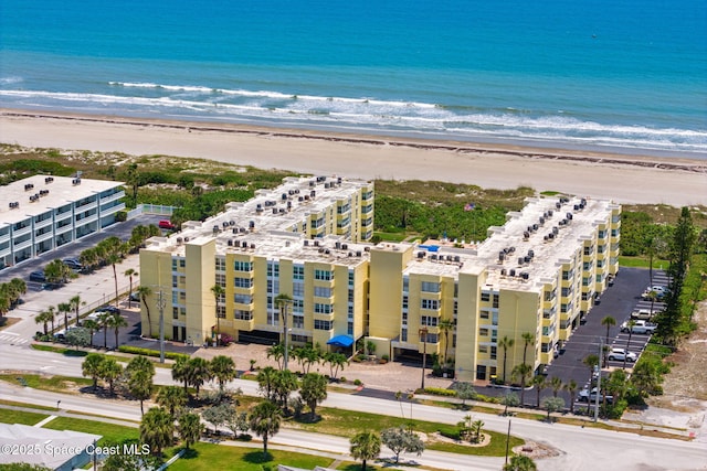 drone / aerial view of apartment complex / building and expansive beach