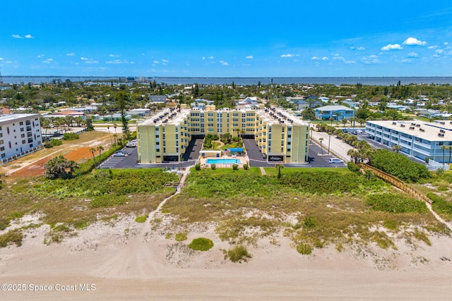 drone / aerial view of a large body of water and apartment complex / building