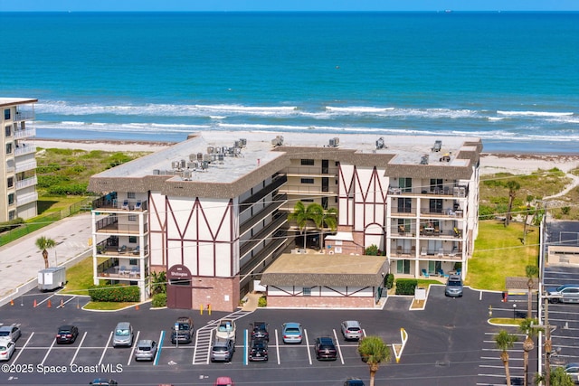 birds eye view of property with a water view and a view of the beach