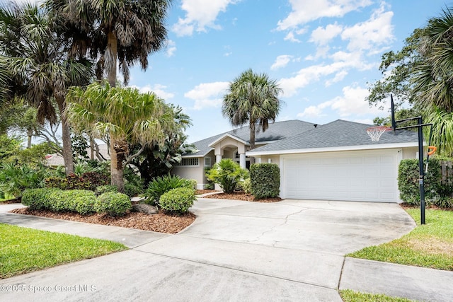 ranch-style home with a garage, stucco siding, concrete driveway, and roof with shingles
