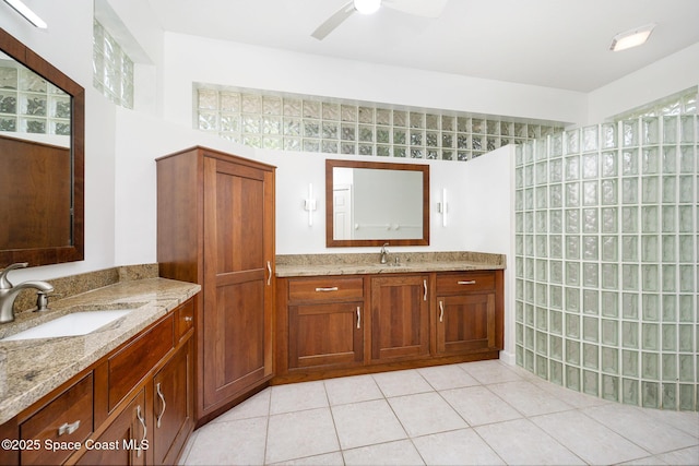 full bathroom with a sink, a ceiling fan, two vanities, and tile patterned floors
