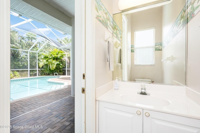 bathroom with a healthy amount of sunlight, vanity, brick floor, and toilet