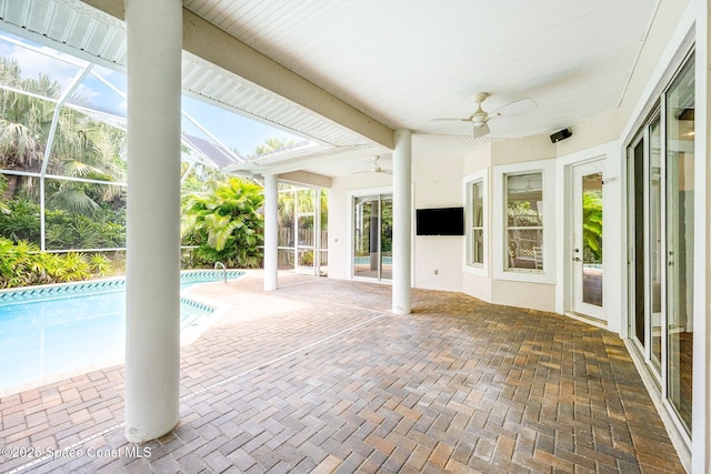 view of patio featuring a lanai, ceiling fan, and an outdoor pool