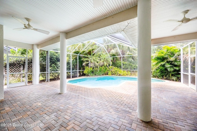 pool with a ceiling fan, glass enclosure, and a patio area