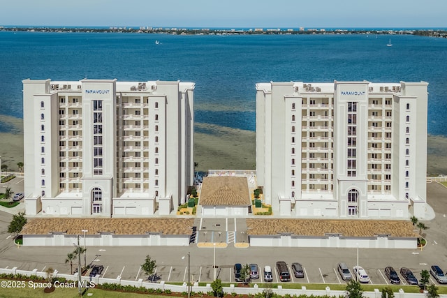 drone / aerial view of apartment complex / building and a large body of water