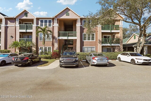 7667 N Wickham Rd Unit 208, Melbourne, FL 32940 - view of building exterior featuring uncovered parking