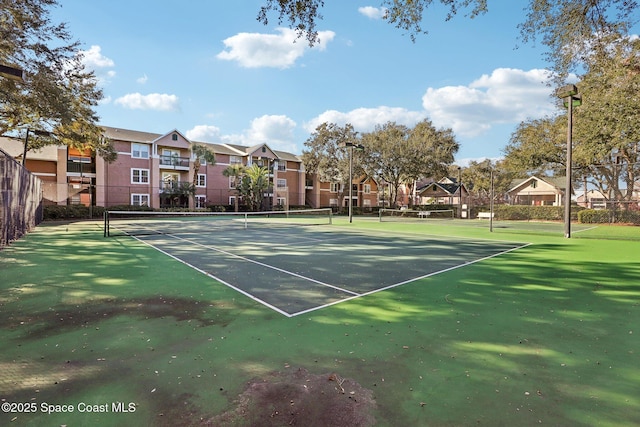 7667 N Wickham Rd Unit 208, Melbourne, FL 32940 - view of sport court with fence and a residential view