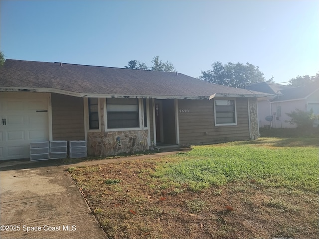 ranch-style house with a front lawn, driveway, roof with shingles, and an attached garage