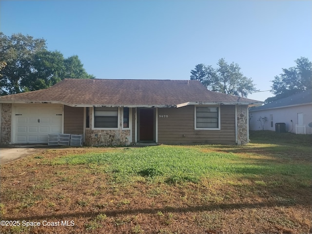 ranch-style home featuring stone siding, a garage, central AC, a front yard, and driveway