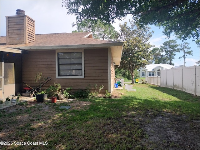 5670 Brandon St, Cocoa, FL 32927 - view of property exterior featuring a chimney and a shingled roof