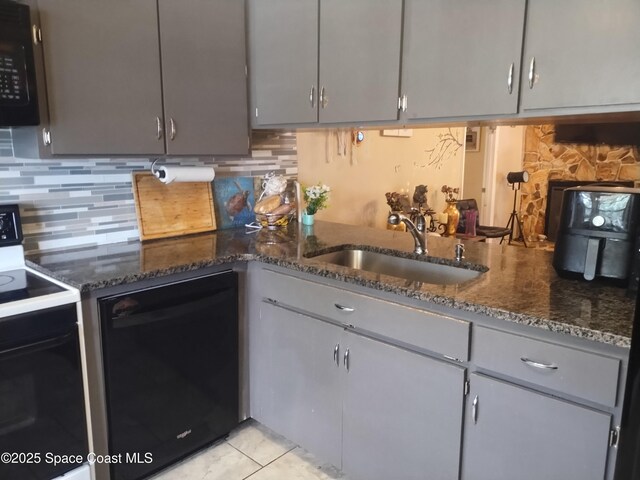 5670 Brandon St, Cocoa, FL 32927 - kitchen with black appliances, a sink, tasteful backsplash, and dark stone counters