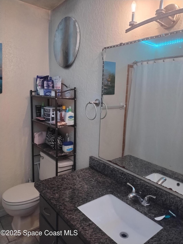5670 Brandon St, Cocoa, FL 32927 - bathroom with a textured wall, vanity, toilet, and a shower with shower curtain