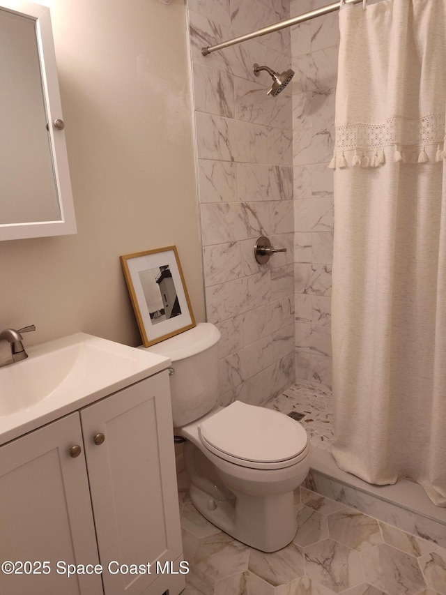 full bath featuring vanity, marble finish floor, toilet, and a shower stall