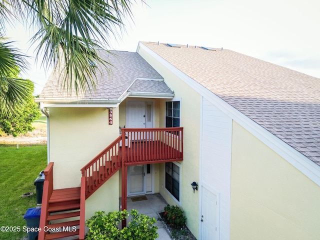 3564 Muirfield Dr Unit 4, Titusville, FL 32780 - rear view of house with roof with shingles, stucco siding, and stairs