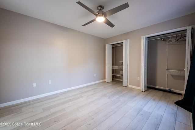 3564 Muirfield Dr Unit 4, Titusville, FL 32780 - unfurnished bedroom featuring multiple closets, baseboards, light wood-type flooring, and ceiling fan