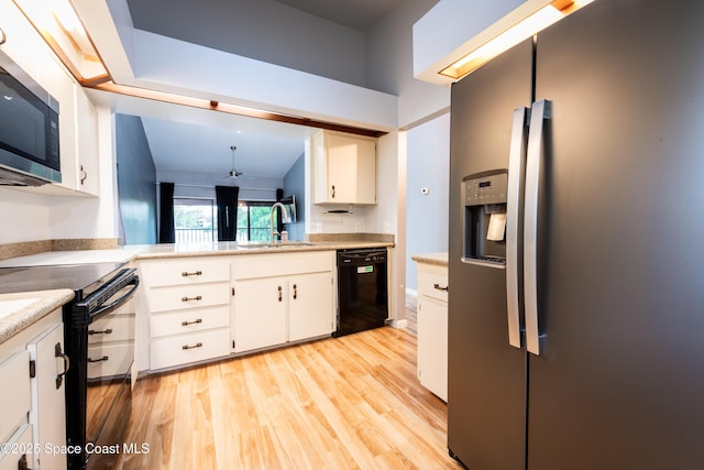 3564 Muirfield Dr Unit 4, Titusville, FL 32780 - kitchen featuring black appliances, a sink, light wood-style flooring, white cabinetry, and light countertops