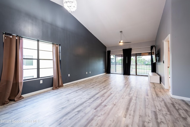 3564 Muirfield Dr Unit 4, Titusville, FL 32780 - empty room with high vaulted ceiling, wood finished floors, baseboards, and ceiling fan