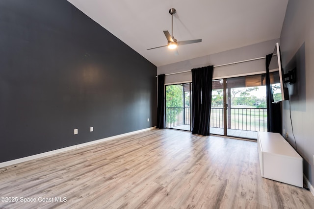 3564 Muirfield Dr Unit 4, Titusville, FL 32780 - unfurnished room with high vaulted ceiling, wood finished floors, a ceiling fan, and baseboards