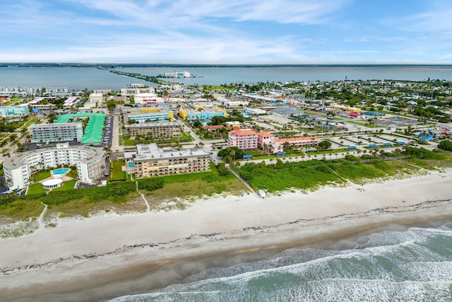 drone / aerial view with a water view and a beach view