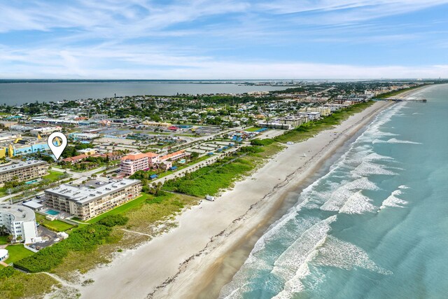 bird's eye view featuring a view of the beach and a water view