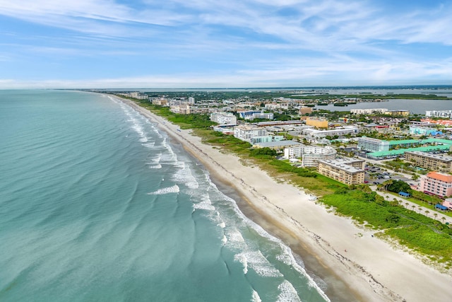 drone / aerial view with a water view and a view of the beach