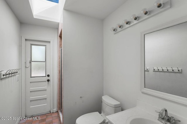 full bath featuring vanity, walk in shower, and toilet