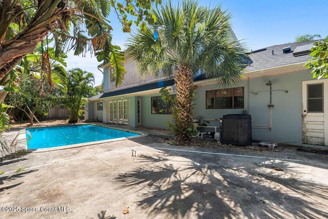 view of pool with a patio, fence, french doors, and a fenced in pool