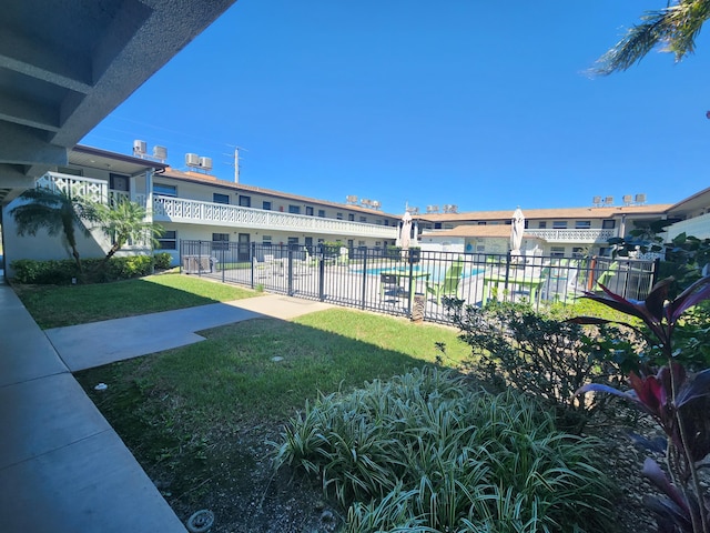 view of yard with fence and a community pool