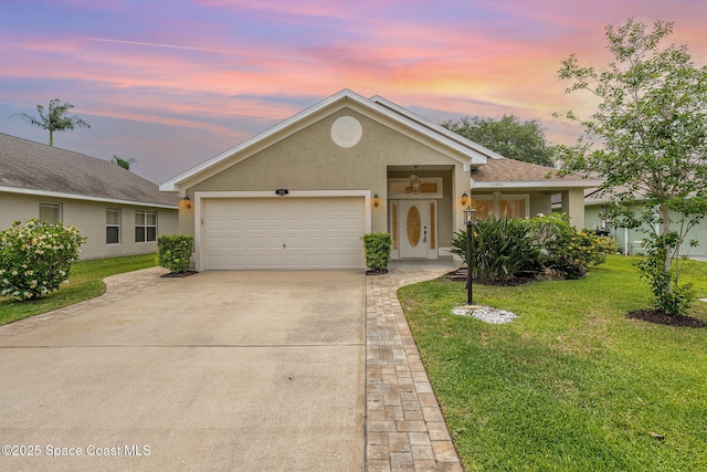 3873 San Miguel Ln, Rockledge, FL 32955 - single story home with stucco siding, concrete driveway, an attached garage, and a front yard
