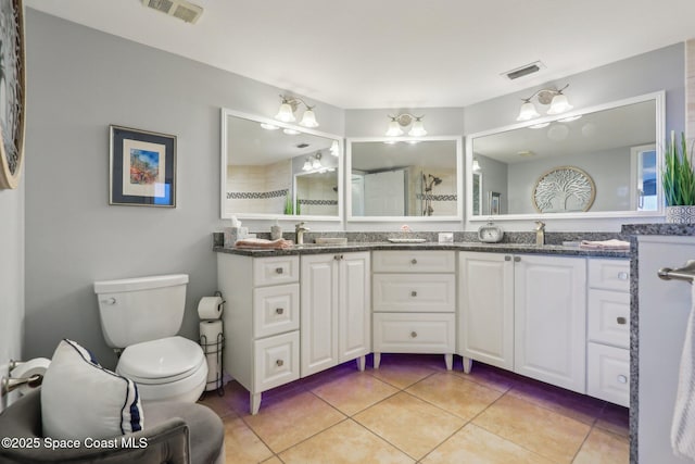 full bathroom with tile patterned flooring, toilet, and double vanity